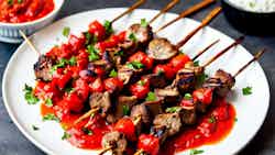 Grilled Goat Skewers with Spicy Tomato Sauce (Inyama ye Inyama ye Inyamaswa n'Isosiyete ye Tomato)